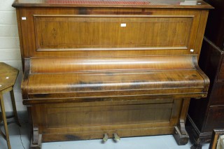 AN UPRIGHT IRON FRAME PIANO