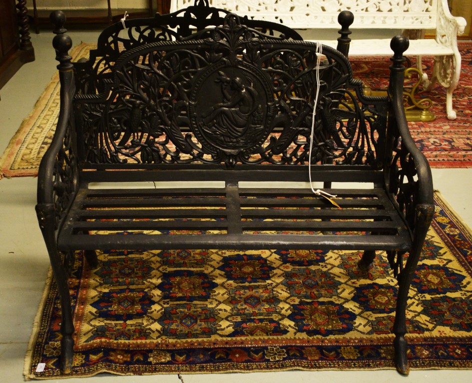 A VERY HEAVY PAIR OF BLACK CAST IRON GARDEN BENCHES