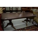 A RECTANGULAR REGENCY STYLE MAHOGANY TWIN PEDESTAL DINING TABLE