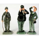 THREE ROYAL DOULTON EARTHENWARE FIGURES OF LAUREL AND HARDY AND CHARLIE CHAPLIN, 23CM H, PRINTED