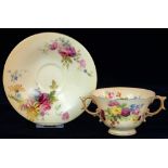 A ROYAL WORCESTER TWO HANDLED CUP AND SAUCER, PRINTED AND PAINTED WITH NATURALISTIC FLOWERS ON A