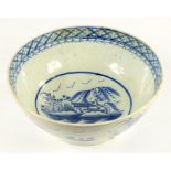 A PEARLWARE BOWL, PAINTED IN UNDERGLAZE BLUE WITH A TEMPLE AND FENCE PATTERN, IN DIAPER BORDER, 26CM