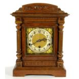 A GERMAN WALNUT ARCHITECTURAL CASED BRACKET CLOCK, THE BRASS DIAL WITH MATTED CENTRE AND PARTLY GILT