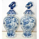 A PAIR OF DUTCH DELFTWARE VASES AND COVERS, PAINTED TO THE FRONT WITH A BIRD IN A LIGHTLY MOULDED