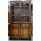 A MAHOGANY GLAZED BOOKCASE, THE BASE WITH PANELLED DOORS, 206 X 115CM