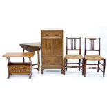 A CARVED OAK TRIANGULAR FOLDING TABLE, OAK CANTERBURY, OAK CUPBOARD AND A PAIR OF RUSH SEATED OAK