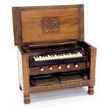 A 19TH C OAK PORTABLE HARMONIUM, FITTED IN A LATER CARVED OAK CHEST