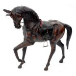 AN ORNAMENTAL LEATHER MODEL OF A PRANCING HORSE, 69CM H