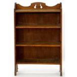 AN ARTS AND CRAFTS STYLE OAK OPEN BOOKCASE, 76CM W, A MAHOGANY BOOK TROUGH AND AN OAK FOLDING TABLE,