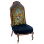 A VICTORIAN WALNUT NURSING CHAIR, WITH EMBROIDERED SEAT ON POTTERY CASTORS