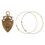 A 9CT GOLD PIERCED SHIELD WATCH FOB PENDANT AND TWO GOLD BANGLES, 7.6G