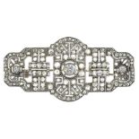 AN ART DECO DIAMOND PLAQUE BROOCH, THE LARGER CENTRAL COLLET SET DIAMOND WEIGHING APPROXIMATELY 0.