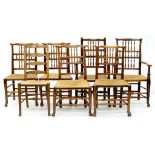 A SET OF SIX VICTORIAN RUSH SEATED OAK DINING CHAIRS, INCLUDING TWO ELBOW CHAIRS AND ANOTHER SIMILAR