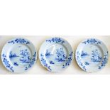 A SET OF THREE ENGLISH DELFTWARE PLATES, PAINTED IN COBALT WITH CHINESE LANDSCAPES, THE BORDER