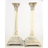 A PAIR OF ELIZABETH II SILVER COLUMNAR CANDLESTICKS, ON STEPPED SQUARE BASE AND BRACKET FEET,