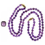 A NECKLACE OF AMETHYST BEADS, GOLD CLASP, MARKED 375 AND AN AMETHYST RING IN GOLD, MARKED 9CT