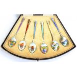 A SET OF SIX GEORGE V SILVER GILT AND ENAMEL COFFEE SPOONS, THE REVERSE OF THE BOWL PAINTED WITH