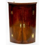 A GEORGE III MAHOGANY BOW FRONTED CORNER CUPBOARD, 96CM H