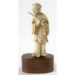 A CHINESE CARVED IVORY FIGURE OF A FLAUTIST, 9CM H EXCLUDING LATER AFFIXED HARDWOOD BASE, LATE