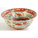 A CHINESE PORCELAIN BOWL, PAINTED IN RED, GREEN AND YELLOW WITH A CENTRAL MEDALLION OF A FIGURE ON A