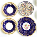 A COALPORT COBALT GROUND PLATE, DECORATED TO THE CENTRE WITH FLOWERS IN LIGHTLY MOULDED GILT BORDER,