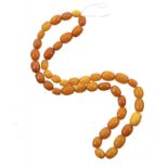 SIXTY TWO AMBER BEADS 33.5g