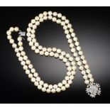 A TWO ROW NECKLACE OF CULTURED PEARLS WITH DIAMOND CLASP of approximately 7-7.5mm cultured pearls,