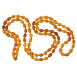 A NECKLACE OF NINETY FIVE AMBER BEADS 85.6