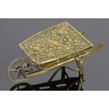 A VICTORIAN EMBOSSED BRASS WHEELBARROW OF ROSES NOVELTY NEEDLEPACKET BOX BY W AVERY & SON, C1874 9cm