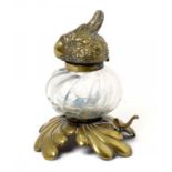 A VICTORIAN BRASS MOUNTED GLASS NOVELTY INKWELL, C1880 the lid cast as the head of a parrot, 15cm