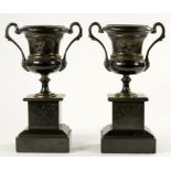 A PAIR OF FRENCH PATINATED METAL TWO HANDLED CAMPANA SHAPED VASES, ON POLISHED SLATE PLINTH, 29CM H,