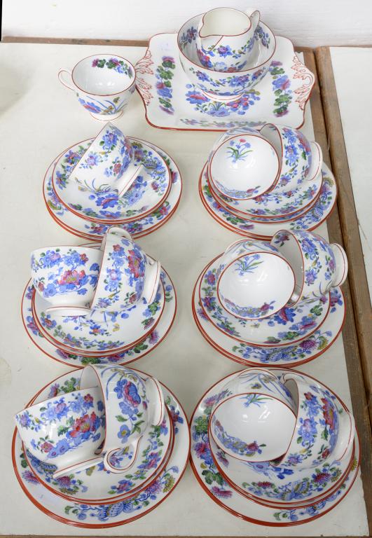 A WEDGWOOD BONE CHINA TEA SERVICE, PRINTED IN BRIGHT BLUE AND ENAMELLED WITH CHINESE PLANTS, THE RIM