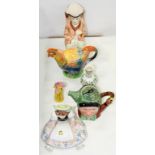 A LENCI TYPE ITALIAN EARTHENWARE FIGURE OF A SEATED GIRL ALARMED BY A SPIDER ON HER APRON, 16CM H,