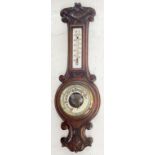 A CARVED OAK ANEROID BAROMETER WITH MERCURY THERMOMETER, 57CM H, C1900 AND AN OCTAGONAL OAK MIRROR