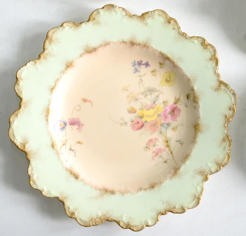 A ROYAL CROWN DERBY PLATE, PRINTED AND PAINTED WITH WILD FLOWERS ON A PASTEL PINK AND GREEN