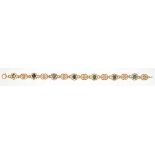 A GOLD BRACELET OF PIERCED LINKS, SET WITH BLACK OPALS AT INTERVALS, MARKED 9K, 10.9G