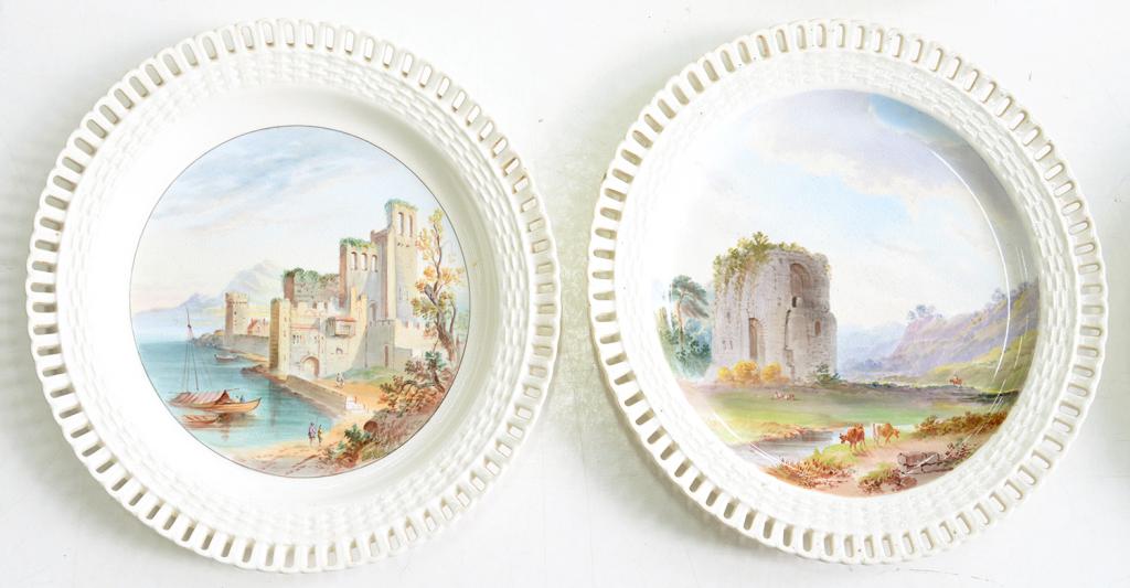 A PAIR OF MINTON PIERCED EARTHENWARE PLATES, OUTSIDE DECORATED, PAINTED WITH LANDSCAPES, 22.5CM D,