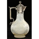 A SILVER MOUNTED GLASS CLARET JUG