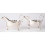 A PAIR OF VICTORIAN SILVER SAUCE BOATS IN 18TH C STYLE, WITH LEAF CAPPED FLYING SCROLL HANDLE, ON