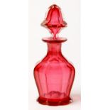 A VICTORIAN CRANBERRY GLASS FACETED SCENT BOTTLE AND STOPPER, ON SCALLOPED FOOT, 11CM H