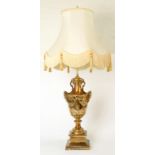 A NEO CLASSICAL STYLE GILT RESIN TABLE LAMP, WITH SATYR MASK HANDLES, 51CM H EXCLUDING FITMENT