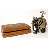 AN INDIAN CARVED EBONY ELEPHANT ORNAMENT, CAPARISONED IN COLOURED GLASS - JEWELLED SILVERED BRASS,