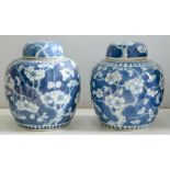 TWO CHINESE BLUE AND WHITE GINGER JARS AND COVERS, PAINTED WITH PRUNUS ON A CRACKED ICE GROUND, 14.