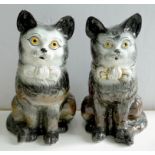 A PAIR OF STAFFORDSHIRE EARTHENWARE MODELS OF GLASS EYED CATS IN BOWS, 34CM H, LATE 19TH / EARLY