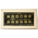 AN EARLY 20TH ELECTRIC SERVANT'S HALL CALL BOARD, WITH BLACK AND GILT GLASS FRONT, 44CM W