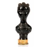 AN UNUSUAL BRASS AND BONE DESK SEAL, THE BLACK THERMOPLATE HANDLE MOULDED AS A BUST OF QUEEN