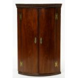 A GEORGE III MAHOGANY AND LINE INLAID BOW FRONTED CORNER CUPBOARD, 75CM W