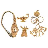 FIVE VARIOUS GOLD CHARMS, INCLUDING A RABBIT, 10.5G AND A GOLD LADY'S TONNEAU SHAPED WRISTWATCH ON