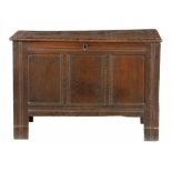 A QUEEN ANNE OAK CHEST, EARLY 18TH C, of three panel construction with channelled frame, the