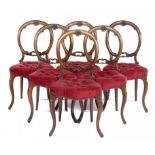 A SET OF SIX VICTORIAN WALNUT DINING CHAIRS, C1870, the open back crested by a carved scallop shell,